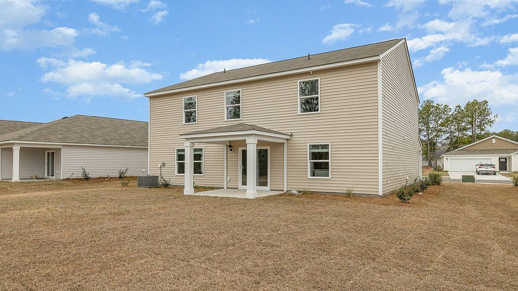 Front exterior of a new home in The Meadows at Wildwood Village, Shallotte, NC, highlighting curb appeal (Image 17).