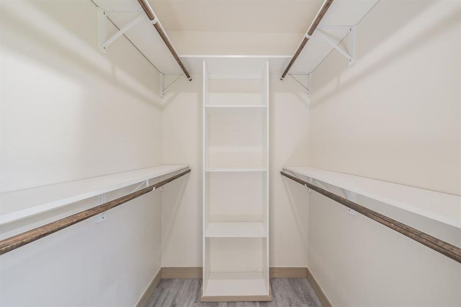 Spacious closet featuring light wood-type flooring