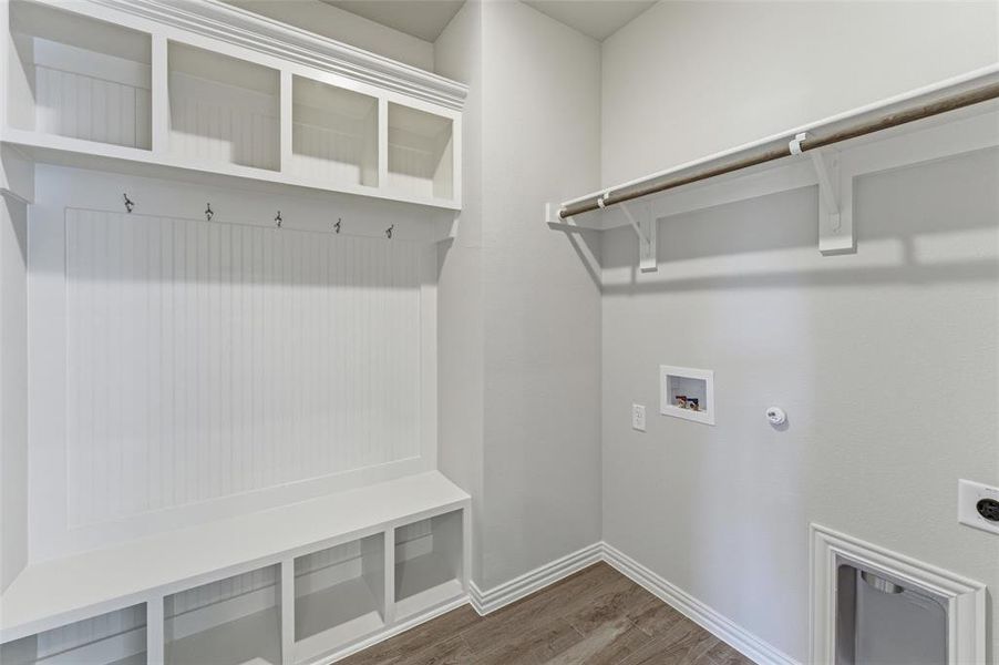 Laundry area with dark wood-style flooring, hookup for a washing machine, hookup for a gas dryer, and hookup for an electric dryer