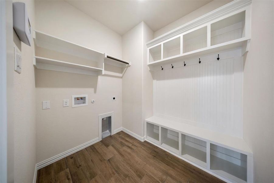 Mudroom featuring dark wood-style floors and baseboards