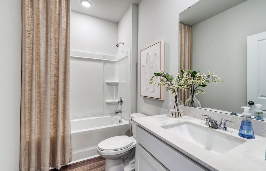 A desirable secondary bath with a soaking tub  perfect for unwinding.