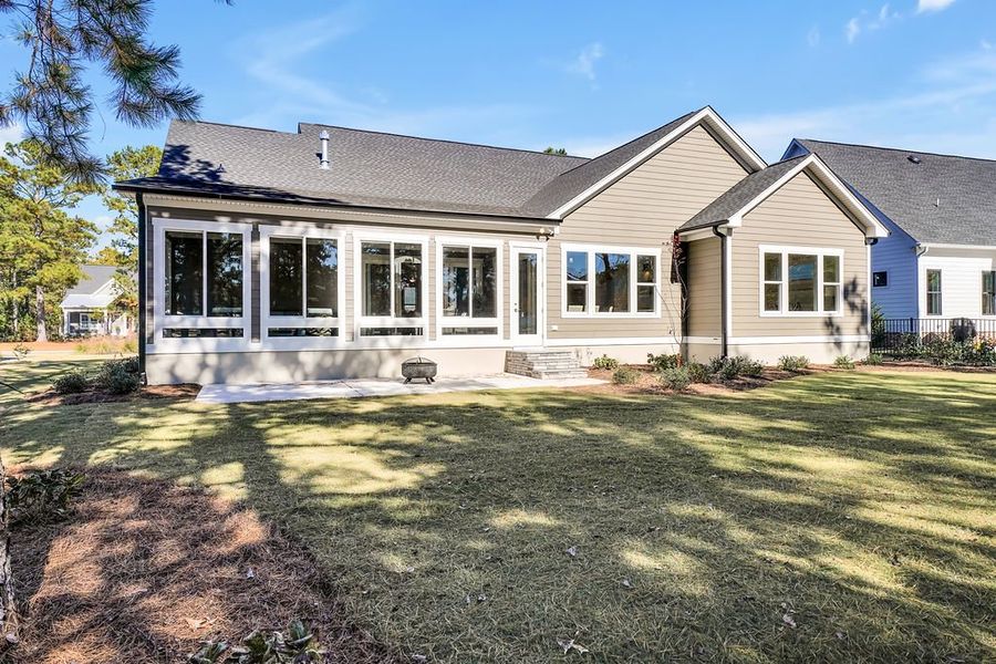 Exterior details and patio area of a home in The Bluffs On the Cape Fear, Leland (Image 29).