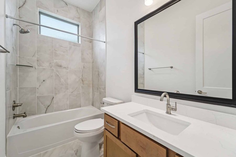 Representative furnished interior of a home built from the Lauren by Chesmar Homes in University Heights, Round Rock (Image 10).