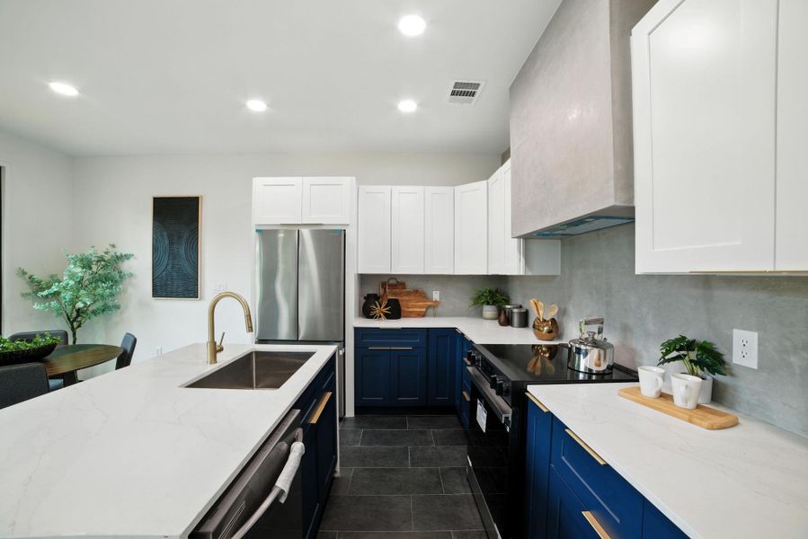 Kitchen featuring blue cabinets, appliances with stainless steel finishes, white cabinets, custom range hood, and recessed lighting Kitchen featuring blue cabinets, appliances with stainless steel finishes, white cabinets, custom range hood, and recessed lighting
