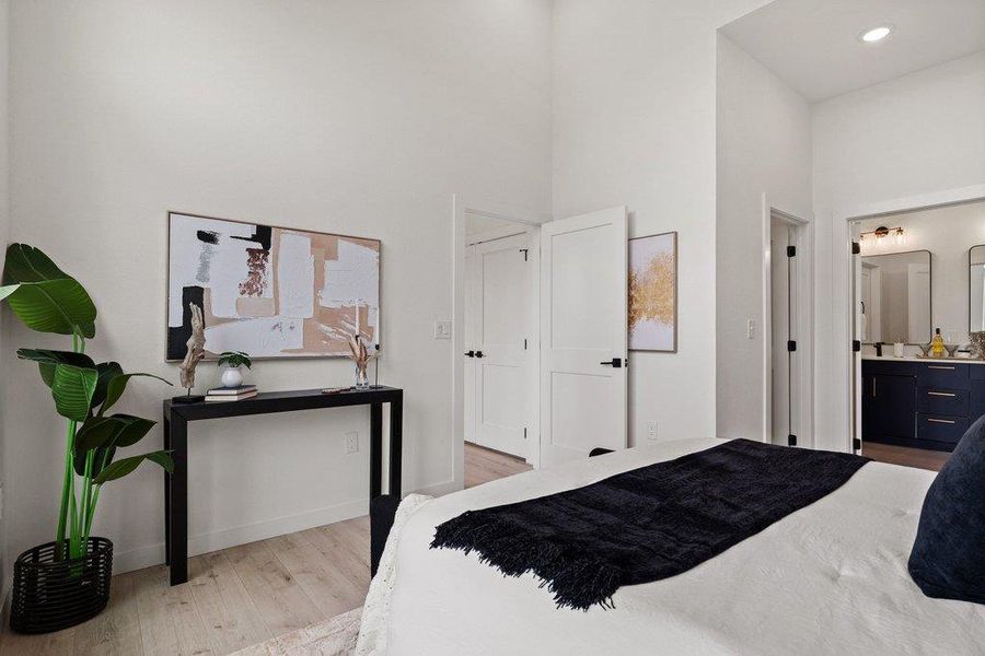 The property features vaulted ceilings, light-colored flooring, and white walls