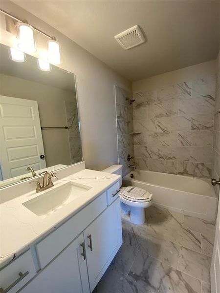 Bath 2 with Monet Quartz vanity, White Shaker cabinets, and oversized 12x24 marble-style tiled shower/bath.