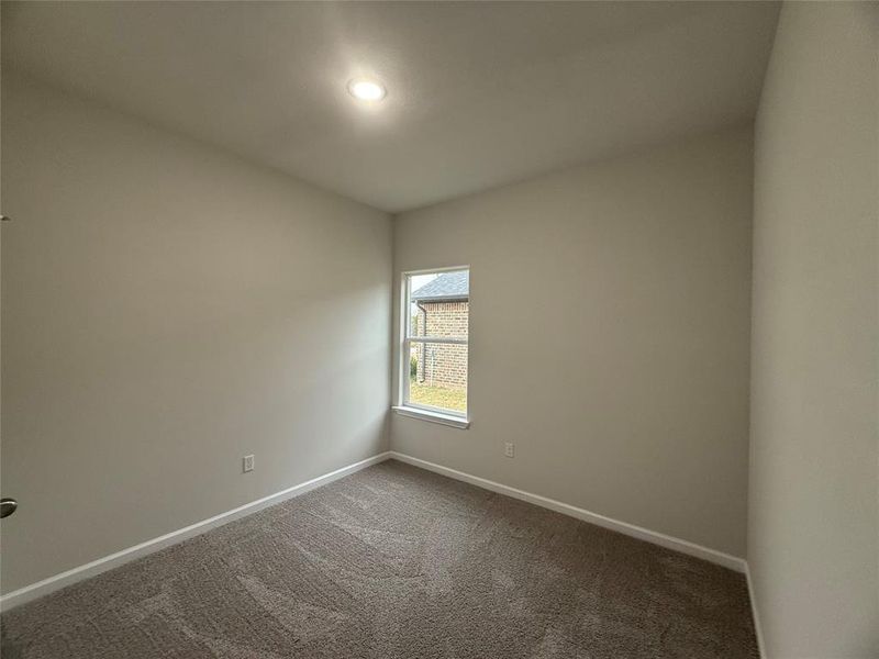 Spare room featuring carpet flooring