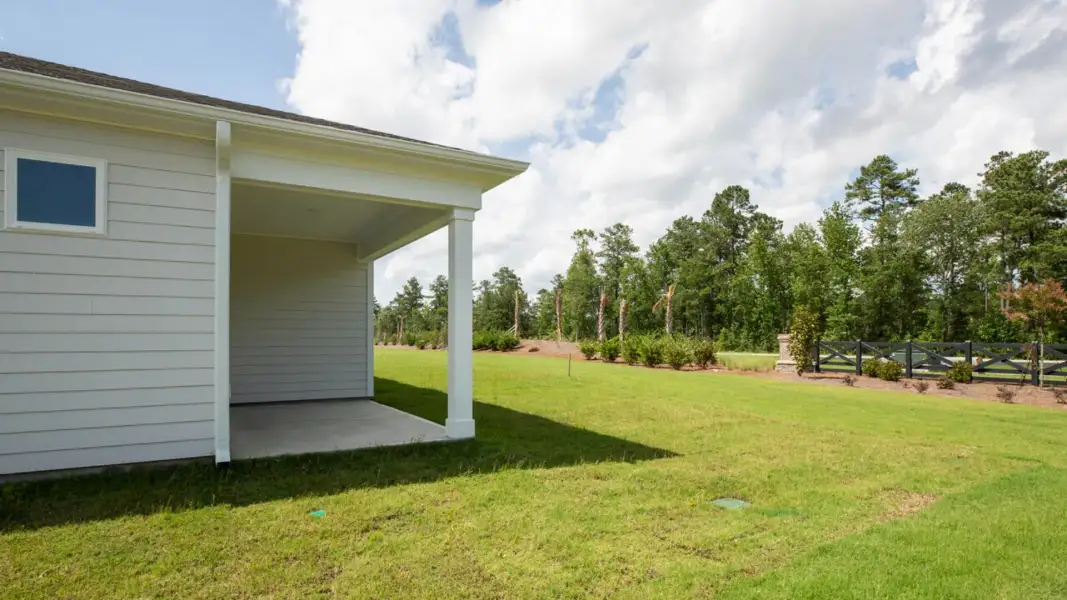 Exterior details and patio area of a home in The Retreat at Indigo Preserve Townhomes, Leland (Image 16).