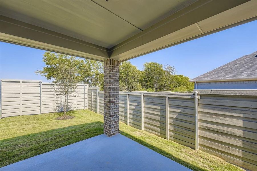 Fenced backyard featuring a patio area Fenced backyard featuring a patio area