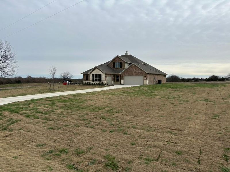 Front exterior of a new home in Fannin Ranch, Leonard, TX, highlighting curb appeal (Image 16).