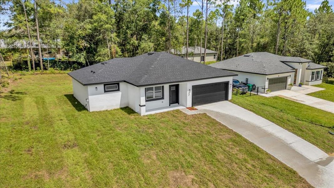 Front exterior of a new home in , Citrus Springs, FL, highlighting curb appeal (Image 2). Front exterior of a new home in , Citrus Springs, FL, highlighting curb appeal (Image 2).