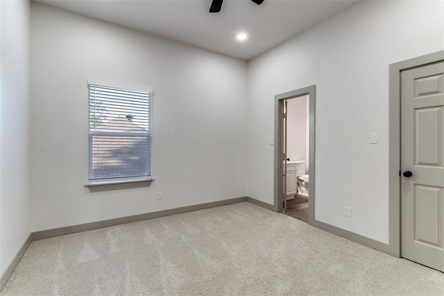 Unfurnished bedroom featuring light carpet, ensuite bath, ceiling fan, and recessed lighting Unfurnished bedroom featuring light carpet, ensuite bath, ceiling fan, and recessed lighting