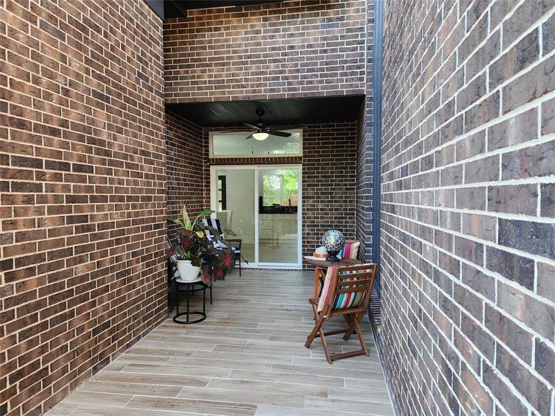 Doorway to property with ceiling fan