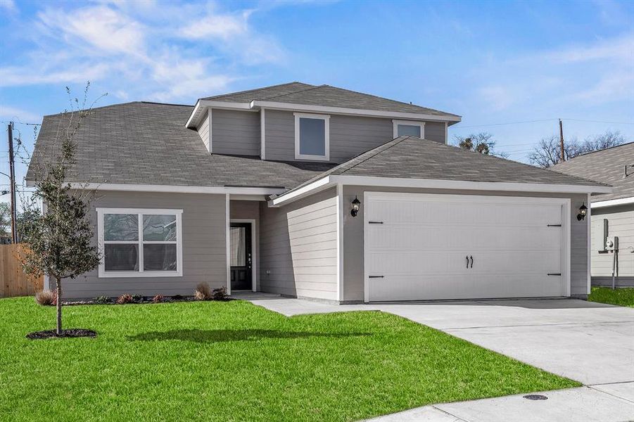 View of front property with a garage and a front yard