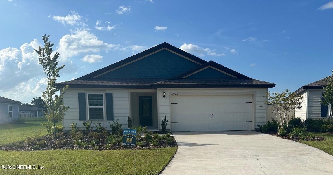 Front exterior of a new home in Whisper Ridge, Hilliard, FL, highlighting curb appeal (Image 1). Front exterior of a new home in Whisper Ridge, Hilliard, FL, highlighting curb appeal (Image 1).