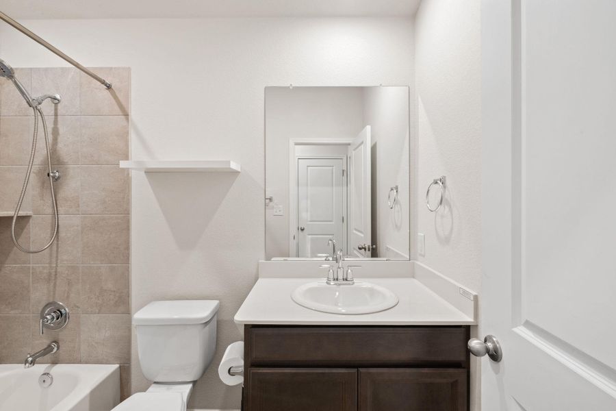 Bathroom featuring vanity and tub / shower combination Bathroom featuring vanity and tub / shower combination