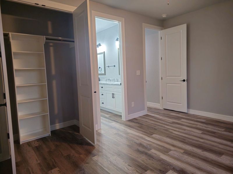 Second bedroom, with a spacious closet with shelving.