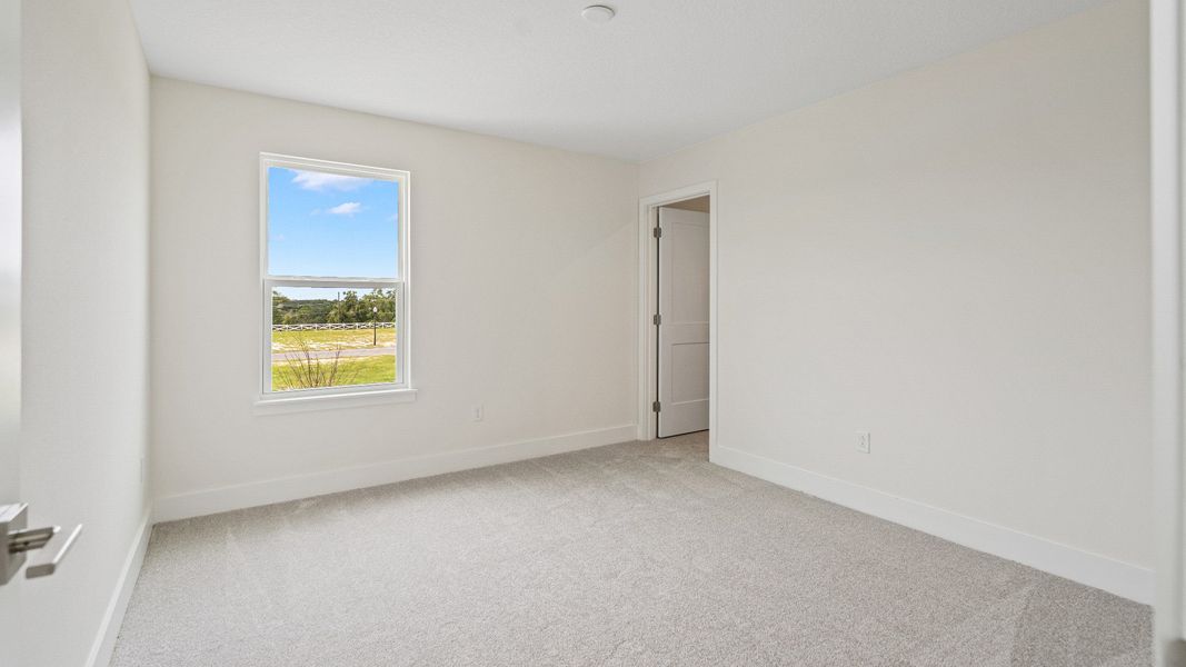 The Sweetgum Spacious and Bright secondary bedroom upstairs in Trailside at Mount Dora by DRB Homes
