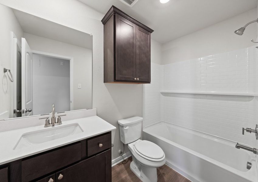 The secondary bathroom has a sprawling vanity and shower-tub combo. The secondary bathroom has a sprawling vanity and shower-tub combo.