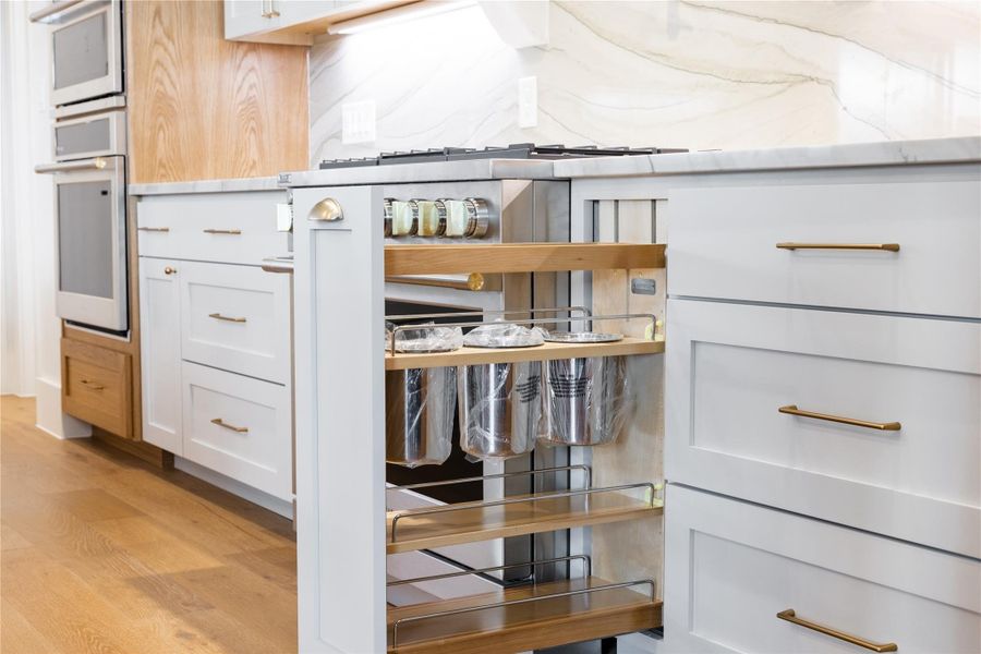 Custom cabinetry with pull out utensil organizer