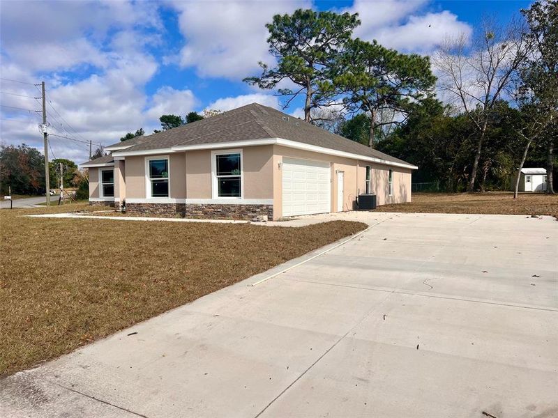 Side garage entry with long driveway