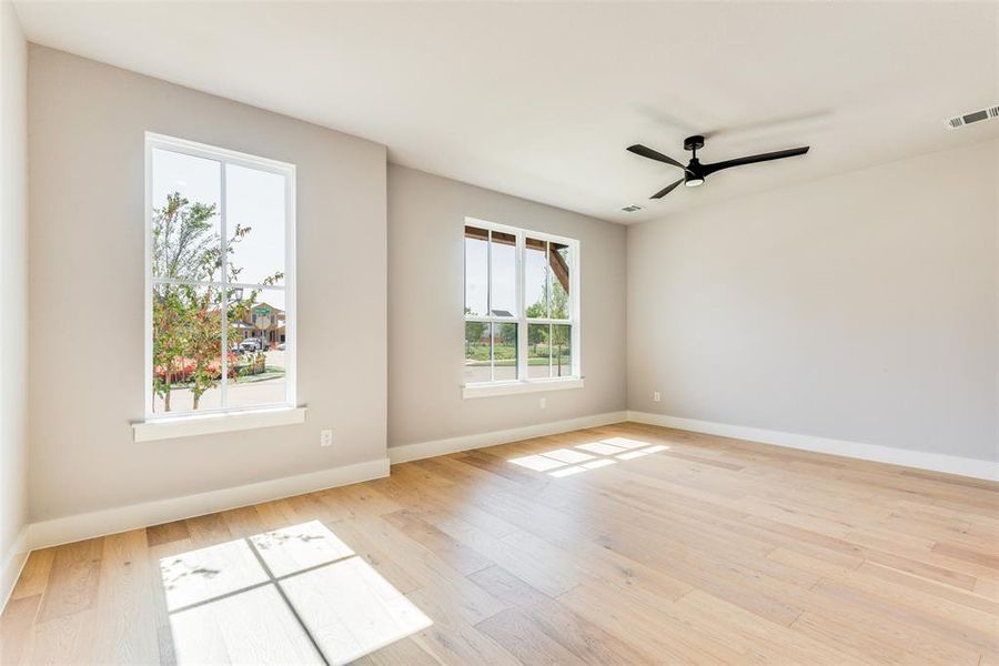 Spare room featuring ceiling fan and light hardwood / wood-style flooring