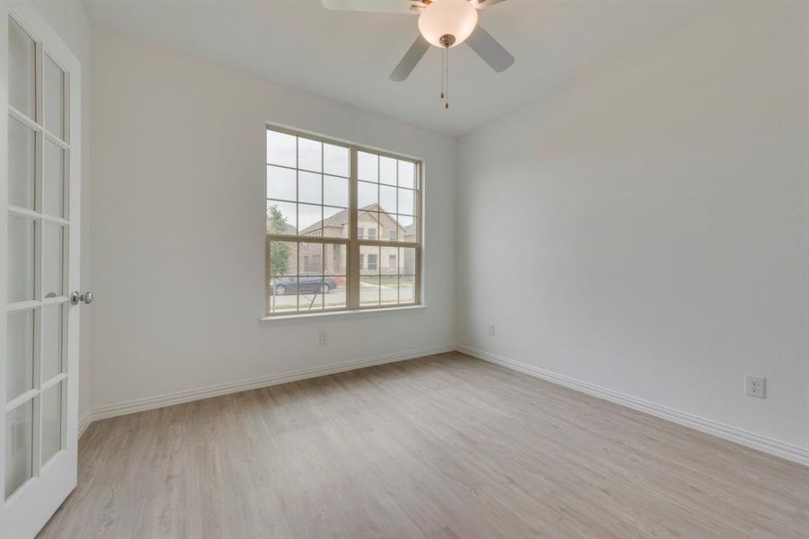 Empty room featuring ceiling fan and light hardwood / wood-style floors