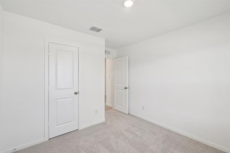 Unfurnished bedroom with carpet floors and baseboards Unfurnished bedroom with carpet floors and baseboards