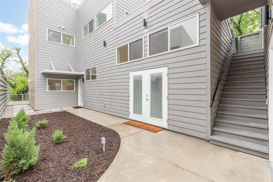 Nice courtyard with steps leading to casita apartment over garage.