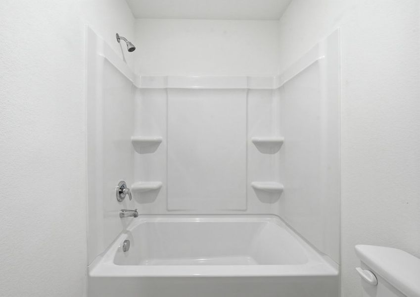 Secondary bathroom featuring a tub and shower combination with tile surround. Secondary bathroom featuring a tub and shower combination with tile surround.