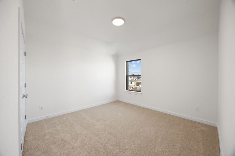 Bedroom in the Pearl home plan by Trophy Signature Homes – REPRESENTATIVE PHOTO