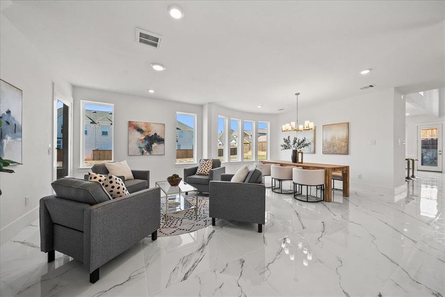 Sitting and dining area featuring a chandelier, plenty of natural light, marble floors, and recessed lighting Sitting and dining area featuring a chandelier, plenty of natural light, marble floors, and recessed lighting