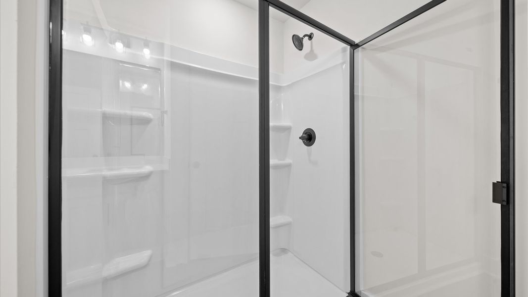 Superior en-suite primary bathroom with stylish dual vanity and walk-in shower crafted with high standards in mind Superior en-suite primary bathroom with stylish dual vanity and walk-in shower crafted with high standards in mind