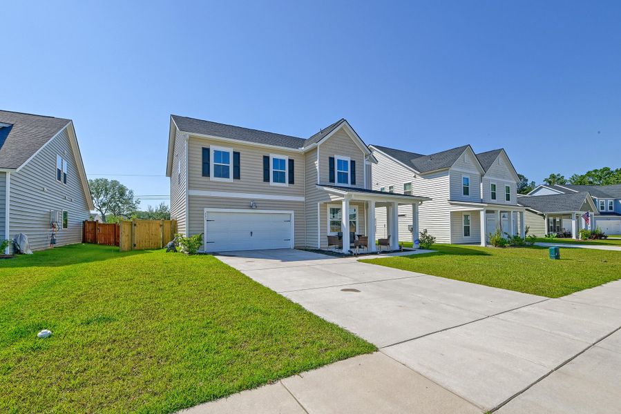 Front exterior of a new home in Heron's Walk at Summers Corner, Summerville, SC, highlighting curb appeal (Image 20).