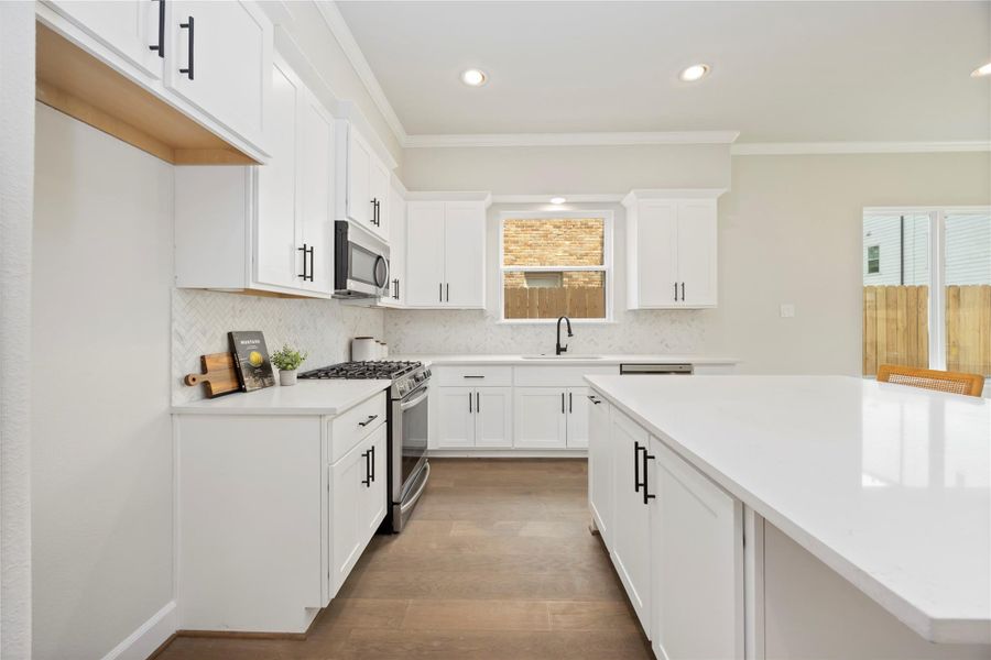 Culinary excellence awaits in a kitchen adorned with a large island, abundant quartz countertops, and ample space for two chefs to work together seamlessly. Enjoy the convenience of soft-close drawers and a waste bin pull-out, adding a touch of luxury to your cooking experience.