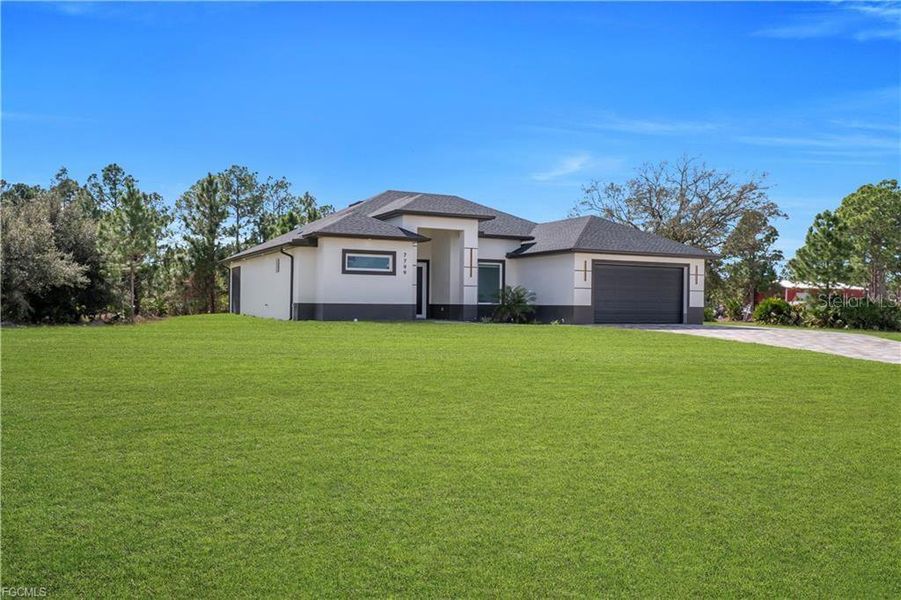 Front exterior of a new home in , Labelle, FL, highlighting curb appeal (Image 2). Front exterior of a new home in , Labelle, FL, highlighting curb appeal (Image 2).