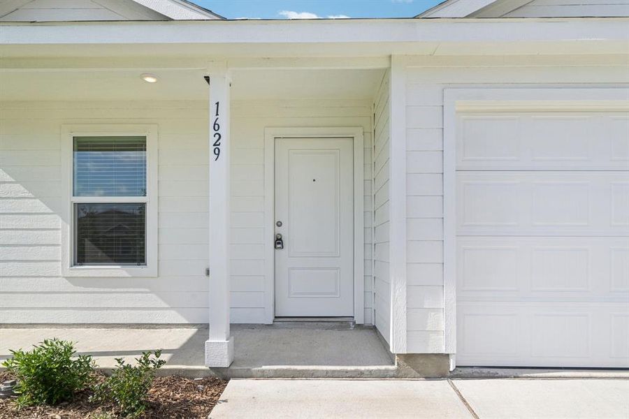 Property entrance with a garage