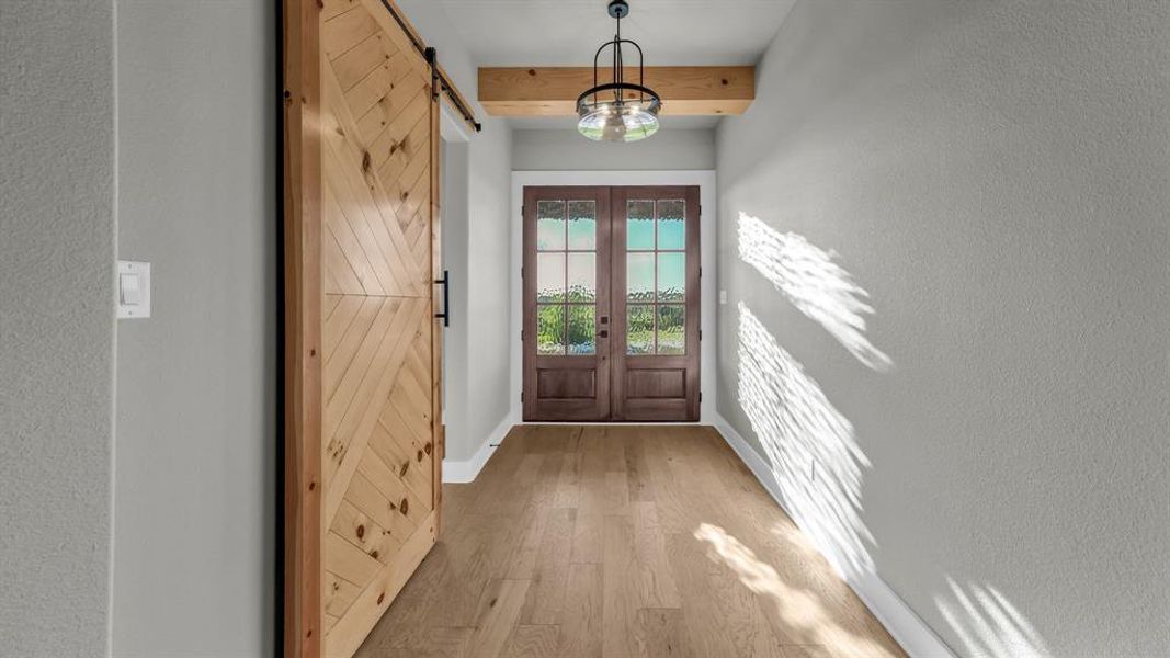 Wood-finish flooring throughout the entryway Wood-finish flooring throughout the entryway