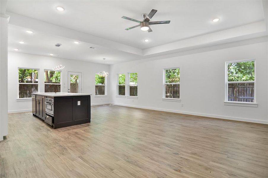 Living room with light hardwood / wood-style flooring and ceiling fan