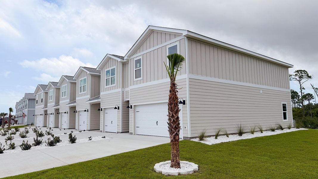 Front exterior of a new home in WindMark Beach, Port Saint Joe, FL, highlighting curb appeal (Image 25).
