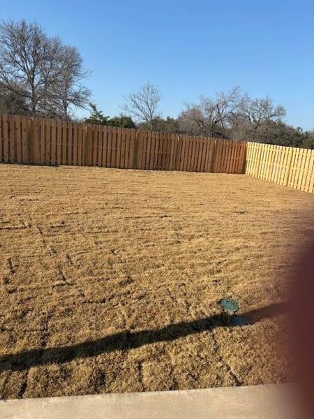 View of yard featuring fence