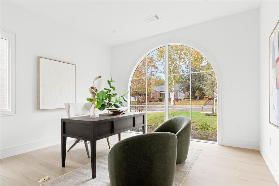 Office space featuring light wood-style flooring and baseboards