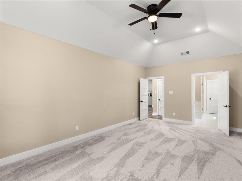 Unfurnished bedroom featuring light carpet, a ceiling fan, recessed lighting, and vaulted ceiling