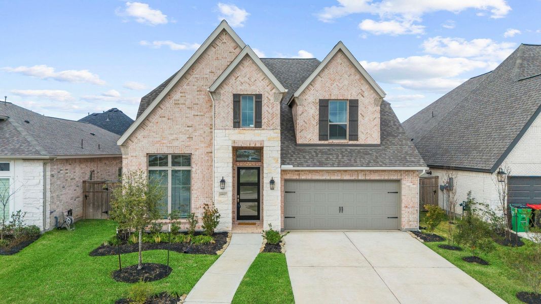 A wide-angle view of the pristine 2025-built Perry Home, showcasing the sprawling driveway and elegant architectural peaks. A wide-angle view of the pristine 2025-built Perry Home, showcasing the sprawling driveway and elegant architectural peaks.