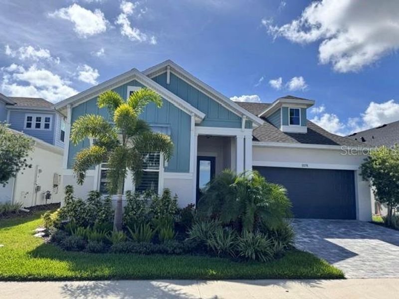 Front exterior of a new home in Emerald Landing at Waterside at Lakewood Ranch – Lake Series, Sarasota, FL, highlighting curb appeal (Image 1). Front exterior of a new home in Emerald Landing at Waterside at Lakewood Ranch – Lake Series, Sarasota, FL, highlighting curb appeal (Image 1).
