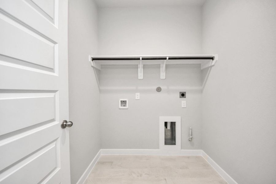 A perfect blend of functionality and comfort. Capture the essence of easy living with a first-floor laundry room, thoughtfully equipped with shelving for effortless organization. Both electric and gas connections available.
