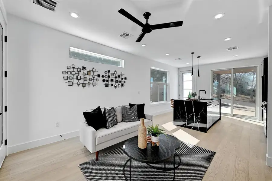 Living area featuring ceiling fan, light wood-style flooring, recessed lighting, and baseboards