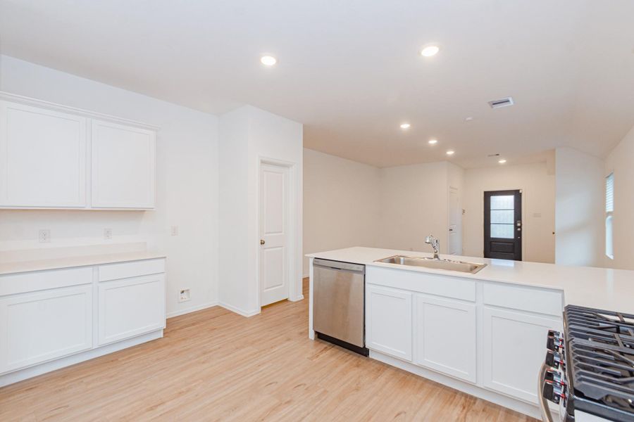 Sleek modern kitchen with ample storage and expansive countertops.