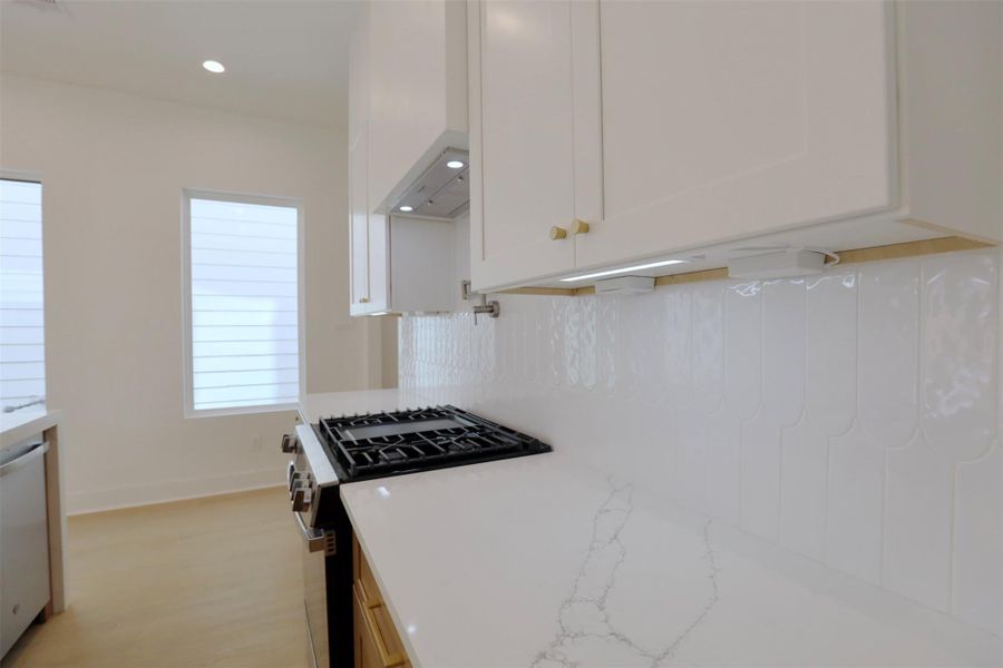 The uninterrupted backsplash is illuminated by the under cabinetry lights, paired with outlets for an increase of kitchen cooking ease. The uninterrupted backsplash is illuminated by the under cabinetry lights, paired with outlets for an increase of kitchen cooking ease.