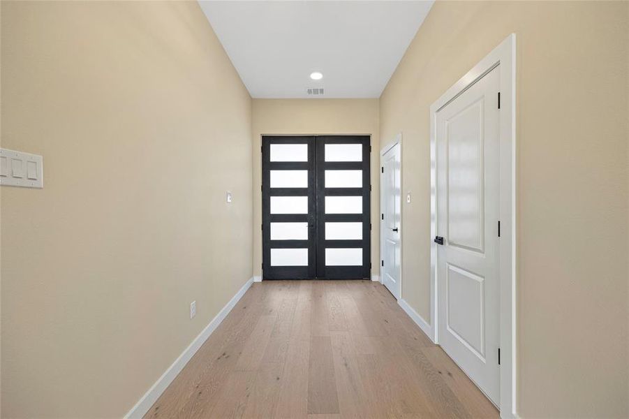 Doorway to outside featuring light hardwood / wood-style floors and french doors